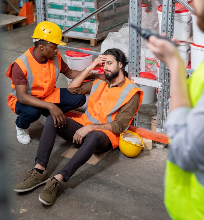 Fatigued warehouse worker experiencing a safety incident due to workplace fatigue and poor sleep